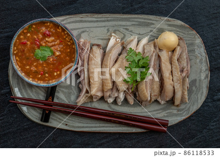 Asian food style marinated steamed chicken (Betong Chickken) and sauce on ceramic plate. Serving chilled as an appetizer. Asian food style marinated steamed chicken (Betong Chickken) and sauce on ceramic plate. Serving chilled as an appetizer. 86118533
