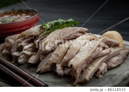 Asian food style marinated steamed chicken (Betong Chickken) and sauce on ceramic plate. Serving chilled as an appetizer. Asian food style marinated steamed chicken (Betong Chickken) and sauce on ceramic plate. Serving chilled as an appetizer. 86118535