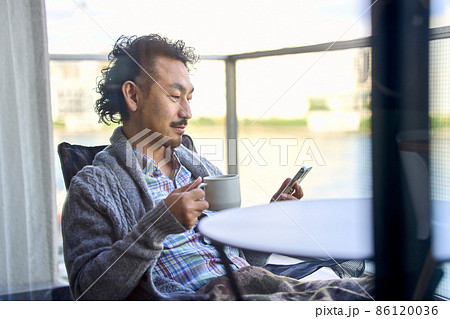 ベランダでリモートワークする髭の男性 ベランダでリモートワークする髭の男性 86120036