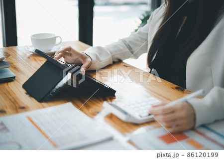 Asian accountant woman working audit budget and finance of company on wooden desk in office. consult, business, tax concept. 86120199