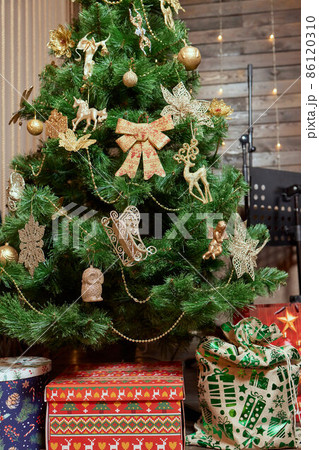 Fir branch with balls and festive lights on the Christmas background. Fir branch with balls and festive lights on the Christmas background. 86120310