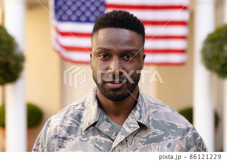 Portrait of confident male african american soldier wearing uniform against usa flag 86121229