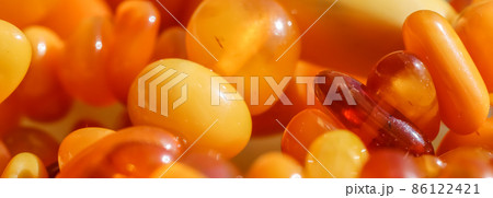 Sunny beads of fire amber. Natural gemstone background, jewelry concept 86122421