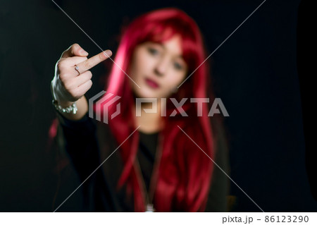 A girl with red hair does the middle finger 86123290