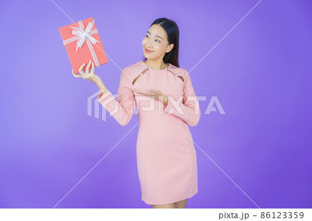 Portrait beautiful young asian woman smile with red gift box Portrait beautiful young asian woman smile with red gift box 86123359