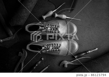 Handcrafted brown leather shoes with cobbler tools Handcrafted brown leather shoes with cobbler tools 86123794