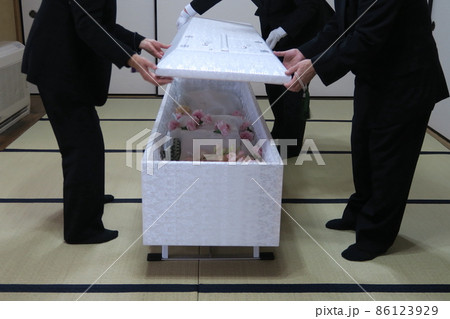 お棺のふたを閉じる親族 86123929