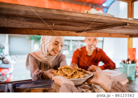 muslim couple ordering food to break fasting in ramadan muslim couple ordering food to break fasting in ramadan 86125562
