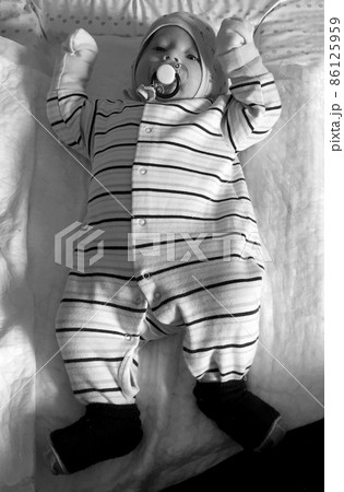 Beautiful baby boy with child face posing photographer Beautiful baby boy with child face posing photographer 86125959