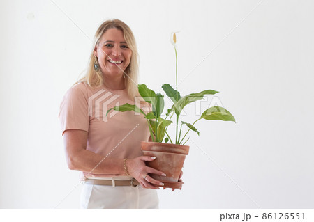 Happy woman moving things into new house Happy woman moving things into new house 86126551