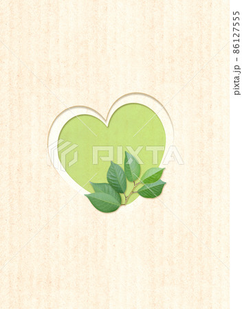 Heart shape hole and green leaves on cardboard texture. Ecology concept Heart shape hole and green leaves on cardboard texture. Ecology concept 86127555