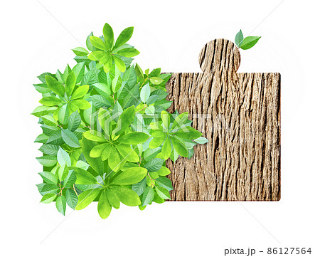 Eco friendly home concept. Two connected puzzle parts made from green leaves and tree bark Eco friendly home concept. Two connected puzzle parts made from green leaves and tree bark 86127564