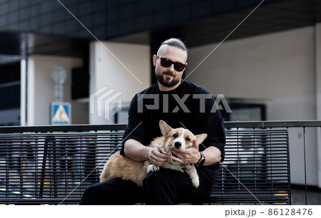 man holds a playful dog man holds a playful dog 86128476