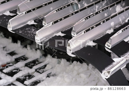 Metal tracks of a snowplow car in winter in the snow Metal tracks of a snowplow car in winter in the snow 86128663