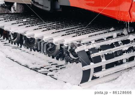 Metal tracks of a snowplow car in winter in the snow Metal tracks of a snowplow car in winter in the snow 86128666