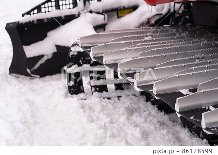 Metal tracks of a snowplow car in winter in the snow Metal tracks of a snowplow car in winter in the snow 86128699