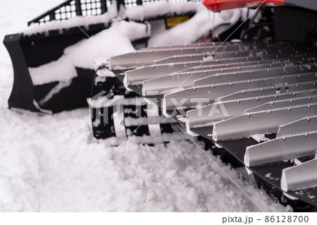 Metal tracks of a snowplow car in winter in the snow Metal tracks of a snowplow car in winter in the snow 86128700