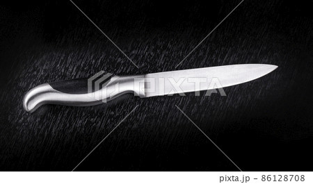 Kitchen knife on black wooden table. Selective focus 86128708
