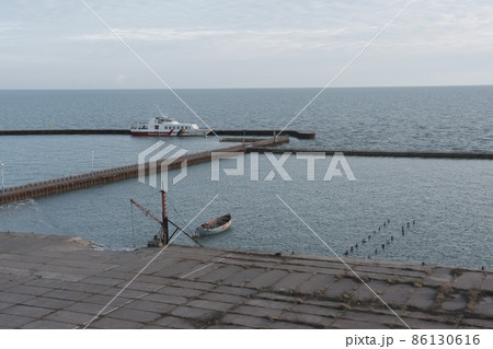 Rescue boat in old marine with crane in winter time of Azov sea 86130616