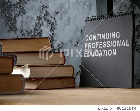 Continuing professional education on the black notepad and books. Continuing professional education on the black notepad and books. 86131984