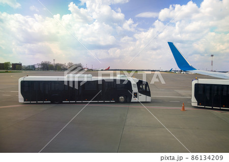Airplane wing and special bus for moving passengers from aircraft to terminal. Airplane wing and special bus for moving passengers from aircraft to terminal. 86134209