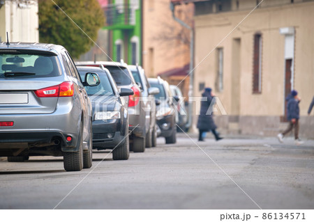 City traffic with cars parked in line on street side City traffic with cars parked in line on street side 86134571