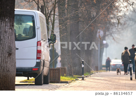 Close up of a van parked illegally against traffic rules on pedestrian city street side 86134657