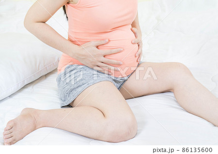 Feeling bad concept - Close up of pregnant woman suffering stomachache. Concept of pregnancy, maternity, health care, gynecology, medicine.Constipation and belly cramps. Feeling bad concept - Close up of pregnant woman suffering stomachache. Concept of pregnancy, maternity, health care, gynecology, medicine.Constipation and belly cramps. 86135600
