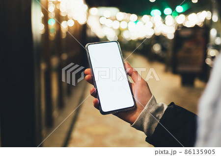 Female hand holding modern smartphone Female hand holding modern smartphone 86135905