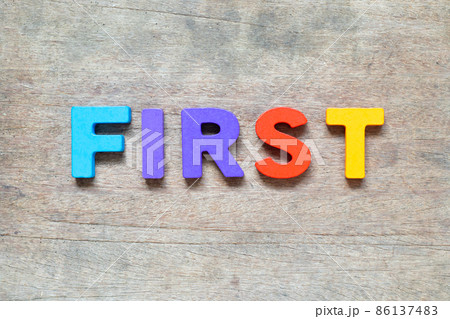 Color alphabet letter with word first on wood background 86137483