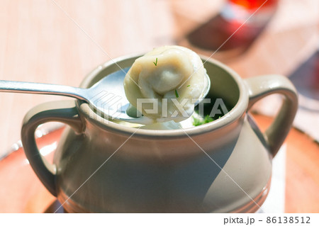 Dumplings in a clay pot, serving dishes in a street cafe, close-up Dumplings in a clay pot, serving dishes in a street cafe, close-up 86138512