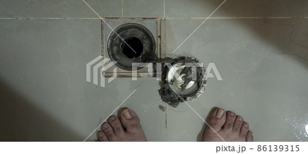 Drain cleaning. Clogged and dirty sewer pipes floor drain. Full of hair and accumulated clogged grease. Maintenance the floor drain sewage system in bathroom. fixing clean wash and unclog a drain. Drain cleaning. Clogged and dirty sewer pipes floor drain. Full of hair and accumulated clogged grease. Maintenance the floor drain sewage system in bathroom. fixing clean wash and unclog a drain. 86139315