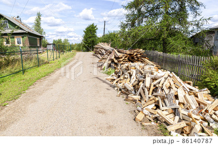 Chopped and stacked up dry firewood at the countryside Chopped and stacked up dry firewood at the countryside 86140787