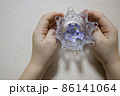 王冠にパープルのお花　こどもの手を添えて　右側に 86141064