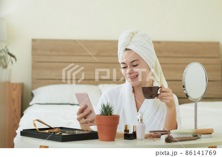 Smiling Woman Checking Phone 86141769