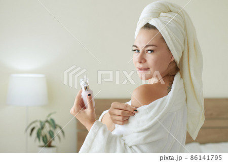 Woman Applying Tightening Serum Woman Applying Tightening Serum 86141795