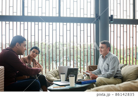 Business People Looking at Talking Colleague 86142835