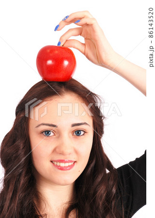 Teen girl holds an apple on her head isolated on white 86143520