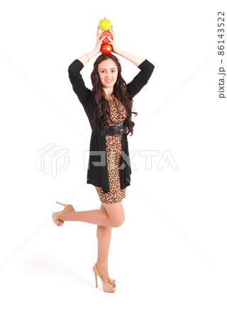 Teen girl holds an three apples on her head Teen girl holds an three apples on her head 86143522