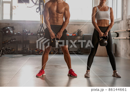 Shot of fitness couple having workout session at gym Shot of fitness couple having workout session at gym 86144661