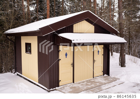 Men's and women's toilets standing in a snowy forest Men's and women's toilets standing in a snowy forest 86145635