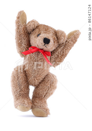 Jumping brown Teddy bear with red ribbon on white background 86147124