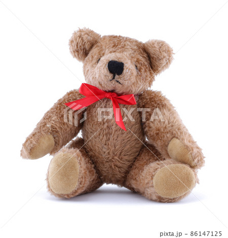 Teddy bear with red ribbon sitting on white 86147125
