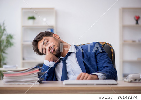 Young male employee extremely tired in the office 86148274