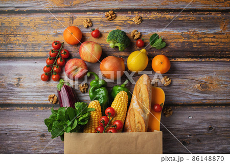 Delivery healthy food background. Healthy vegan vegetarian food in paper bag vegetables and fruits on wood, copy space, banner. Shopping food supermarket and clean vegan eating concept 86148870