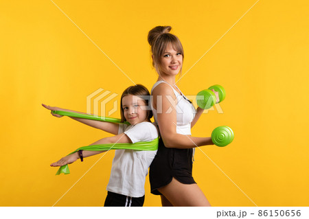 Mom and daughter workouts in studio 86150656