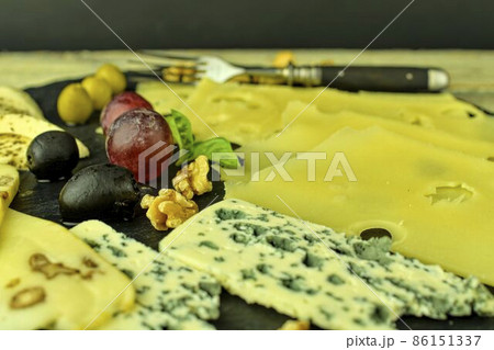 Gourmet wine and cheese charcuterie tray to enjoy on special holiday occasion, share on date nights. Concept, background, copy space, simple lifestyle Gourmet wine and cheese charcuterie tray to enjoy on special holiday occasion, share on date nights. Concept, background, copy space, simple lifestyle 86151337