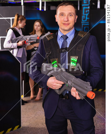 Man holding laser gun and playing laser tag 86154197