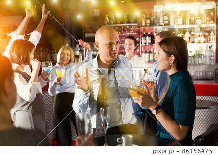 Businessman with female colleague fooling during office party 86156475