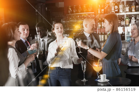 Young women enjoying corporate party Young women enjoying corporate party 86156519
